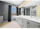 Bathroom boasts double sinks, a large mirror, and a shower with mosaic tile at 2940 Washington St, Columbus, IN 47201