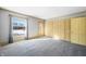 Spacious bedroom with gray carpeting, large windows, and ample closet space at 2940 Washington St, Columbus, IN 47201