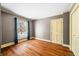 Simple bedroom with hardwood floors and a window overlooking the yard at 2940 Washington St, Columbus, IN 47201