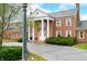 Classic brick home with stately white columns, complemented by lush greenery and a paved driveway at 2940 Washington St, Columbus, IN 47201