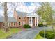 Stately brick home featuring a grand entrance with white columns and a well-manicured front yard at 2940 Washington St, Columbus, IN 47201