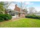 Charming home with brick and white porch, balcony and lush landscaping at 2940 Washington St, Columbus, IN 47201