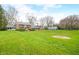 Charming two-story brick home with a spacious lawn, mature trees, and well-maintained landscaping at 2940 Washington St, Columbus, IN 47201