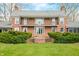 A beautiful brick home with mature landscaping and second story balcony at 2940 Washington St, Columbus, IN 47201