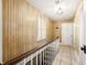 Upper hallway features wood paneling, tile floors, and a staircase at 2940 Washington St, Columbus, IN 47201