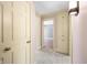 Bright hallway with neutral carpeting, built-in storage and doors at 2940 Washington St, Columbus, IN 47201