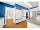 White kitchen with blue walls, wood floors, and stainless steel appliances at 2940 Washington St, Columbus, IN 47201