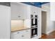 White kitchen with double oven and wood floors at 2940 Washington St, Columbus, IN 47201