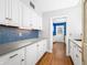 White kitchen with blue tile backsplash and concrete countertops at 2940 Washington St, Columbus, IN 47201