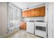 Well-lit laundry room with wooden cabinets and window at 2940 Washington St, Columbus, IN 47201