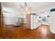 Open living room with hardwood floors, brick fireplace, and kitchen access at 2940 Washington St, Columbus, IN 47201
