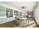 Spacious screened porch with ceiling fan, dining area, and ample seating at 2940 Washington St, Columbus, IN 47201