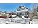 Two-story house with brick front and covered porch, snow-covered yard at 2957 Winthrop Ave, Indianapolis, IN 46205