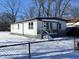 White ranch home with a gray porch and chain link fence at 3038 N Gladstone Ave, Indianapolis, IN 46218