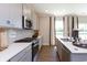 Modern kitchen with gray cabinets, stainless steel appliances, and white countertops at 3231 Wetherby Pl, Danville, IN 46122