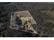Aerial view highlighting home's wooded setting and pond at 3264 W Roberts Rd, Trafalgar, IN 46181