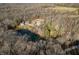 Aerial view showing home, pond, and wooded area at 3264 W Roberts Rd, Trafalgar, IN 46181