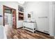 Modern bathroom with white vanity, black countertop, and wood-look floors at 3264 W Roberts Rd, Trafalgar, IN 46181