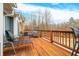 Spacious deck with wooden flooring, wicker furniture, and scenic wooded views at 3264 W Roberts Rd, Trafalgar, IN 46181