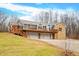 Ranch home with stone accents, expansive deck, and a three-car garage at 3264 W Roberts Rd, Trafalgar, IN 46181
