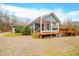 Home with covered porch and deck, offering wooded views at 3264 W Roberts Rd, Trafalgar, IN 46181
