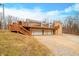House with large deck, three-car garage, and a sloping yard at 3264 W Roberts Rd, Trafalgar, IN 46181