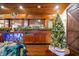Beautiful home bar with a fully stocked back bar and a festive Christmas tree nearby at 3264 W Roberts Rd, Trafalgar, IN 46181