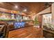 Elegant home bar featuring a long bar top with glass shelving and back bar mirrors at 3264 W Roberts Rd, Trafalgar, IN 46181