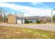 House exterior showcasing a stone garage and a gravel driveway at 3264 W Roberts Rd, Trafalgar, IN 46181