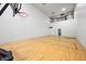 Spacious indoor court with a basketball hoop and hardwood floor at 3264 W Roberts Rd, Trafalgar, IN 46181