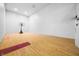 Indoor basketball court with hardwood floors and white walls at 3264 W Roberts Rd, Trafalgar, IN 46181