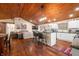 Open concept kitchen and living area with hardwood floors and wood ceiling at 3264 W Roberts Rd, Trafalgar, IN 46181