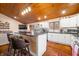 Open concept kitchen with an island and seating, white cabinets, and wood floors at 3264 W Roberts Rd, Trafalgar, IN 46181