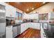 L-shaped kitchen with white cabinets, granite countertops, and stainless steel appliances at 3264 W Roberts Rd, Trafalgar, IN 46181