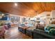 Spacious living area with hardwood floors, comfy seating, and a wood-paneled ceiling at 3264 W Roberts Rd, Trafalgar, IN 46181