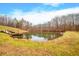 Picturesque pond view with a wooden dock, offering tranquility and natural beauty at 3264 W Roberts Rd, Trafalgar, IN 46181