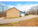 Stone garage with a large door and gravel driveway at 3264 W Roberts Rd, Trafalgar, IN 46181