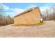 Stone garage with a large door and gravel driveway at 3264 W Roberts Rd, Trafalgar, IN 46181