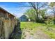 Backyard with a wooden fence and a grass-covered yard space with trees at 35 S Catherwood Ave, Indianapolis, IN 46219