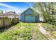 View of the backyard with grass and the blue siding of the house at 35 S Catherwood Ave, Indianapolis, IN 46219
