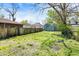 Backyard with a wooden fence and a grass-covered yard space with trees at 35 S Catherwood Ave, Indianapolis, IN 46219