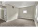 Cozy bedroom with neutral walls, plush carpeting, and a bright window at 35 S Catherwood Ave, Indianapolis, IN 46219