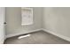 Bedroom features natural light from a window and neutral carpet and walls at 35 S Catherwood Ave, Indianapolis, IN 46219