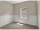 Comfortable bedroom featuring neutral carpet, wainscoting, and a bright window at 35 S Catherwood Ave, Indianapolis, IN 46219