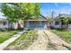 Charming blue home featuring a covered porch with orange pillars and a yard at 35 S Catherwood Ave, Indianapolis, IN 46219