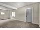 Spacious living room features neutral paint, plush carpeting, and natural light at 35 S Catherwood Ave, Indianapolis, IN 46219