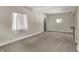 Spacious living room features neutral paint, plush carpeting, and natural light at 35 S Catherwood Ave, Indianapolis, IN 46219