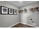 Laundry room with shelving, stylish wall art, and wood flooring at 3647 Planck Cir, Danville, IN 46122