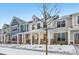 Two-story townhome with front porch, stone accents, and snow-covered landscaping at 3921 Wren Dr, Brownsburg, IN 46112