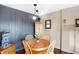 Bright dining area with wood table and chairs near dark gray wall at 3965 N Meridian St # Apt 6C, Indianapolis, IN 46208
